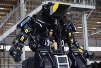 Akinori Ishii, of startup Tsubame Industries Co., sits inside the cockpit of ARCHAX, a giant human-piloted robot developed by him and CEO Ryo Yoshida, in Yokohama on Sept. 27. | REUTERS