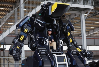 Akinori Ishii, of startup Tsubame Industries Co., sits inside the cockpit of ARCHAX, a giant human-piloted robot developed by him and CEO Ryo Yoshida, in Yokohama on Sept. 27.
