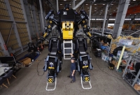 Tsubame Industries Co. CEO Ryo Yoshida poses for a photograph with ARCHAX, a giant human-piloted robot developed by his startup, in Yokohama on Sept. 27. | REUTERS