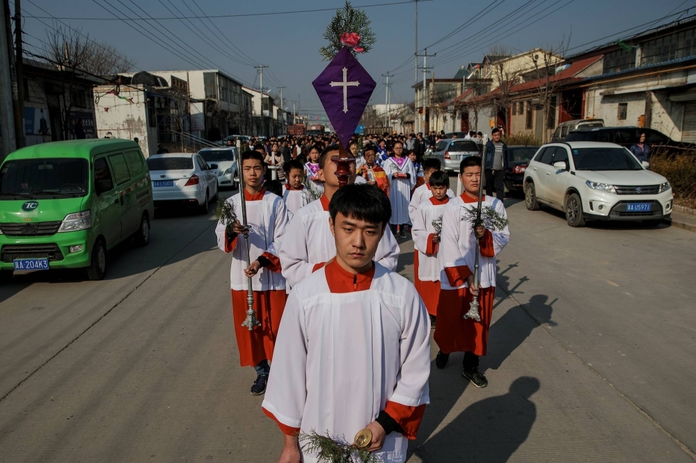 A Palm Sunday procession makes its way toward a government-sanctioned Catholic church in Youtong village in China's Hebei province