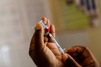 A nurse prepares a malaria vaccine before administering it to an infant in Kisumu, Kenya, in July 2022.