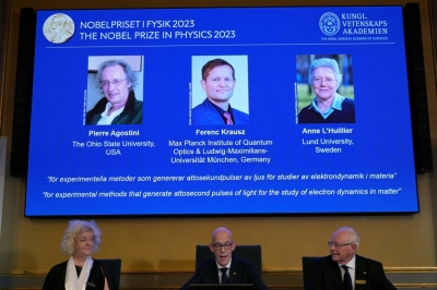 Hans Ellegren, permanent secretary of the Royal Academy of Sciences, flanked by Eva Olsson and Mats Larsson, members, announces this year's Nobel Prize winners in physics, at the Royal Academy of Sciences in Stockholm on Tuesday.. 