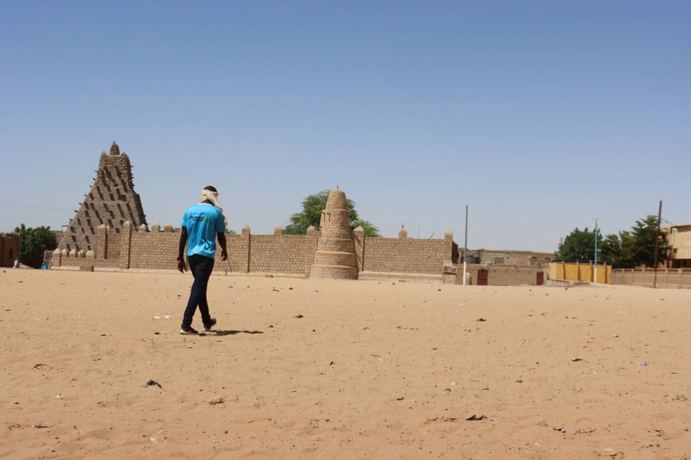 A man walks toward Sankore mosque, also known as the former University of Sankore, in Timbuktu, Mali 