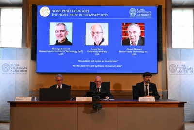 A screen shows this year's winners of the Nobel Prize in chemistry — U.S. chemists Moungi Bawendi and Chemist Louis Brus and Russian physicist Alexei Ekimov — during the announcement of the winners at the Royal Swedish Academy of Sciences in Stockholm on Wednesday. 