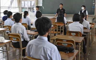 Second-year students at Naka Junior High School in Fukuoka meditate before class in June.