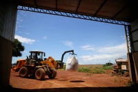 A tractor loads fertilizer before spreading it in a soybean field near Brasilia, Brazil, in February 2022. | REUTERS