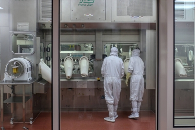 Employees monitor the production of Covishield, the local name for the COVID-19 vaccine developed by AstraZeneca and the University of Oxford, at the Serum Institute of India in Pune, Maharashtra, India.