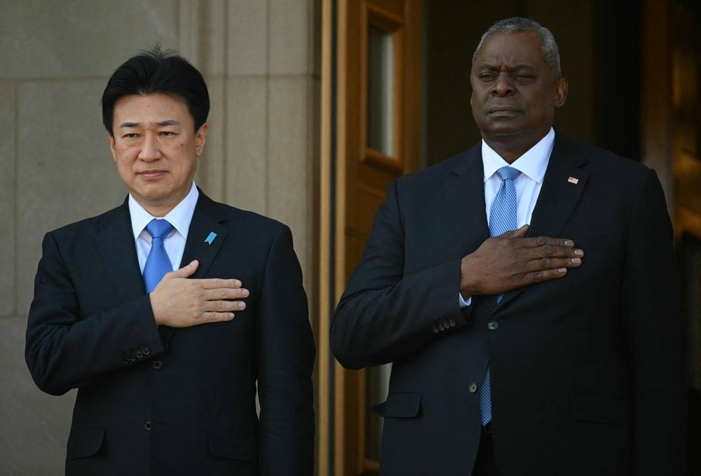 U.S. Defense Secretary Lloyd Austin welcomes Defense Minister Minoru Kihara to the Pentagon in Washington on Wednesday.