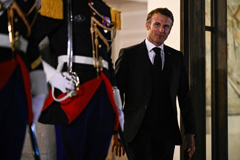 French President Emmanuel Macron arrives to greets Finland's Prime Minister at the Elysee Palace in Paris on Wednesday.
