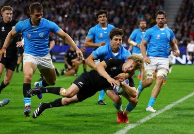 New Zealand's Damian McKenzie scores a try against Uruguay during the Rugby World Cup in Lyon, France, on Thursday.