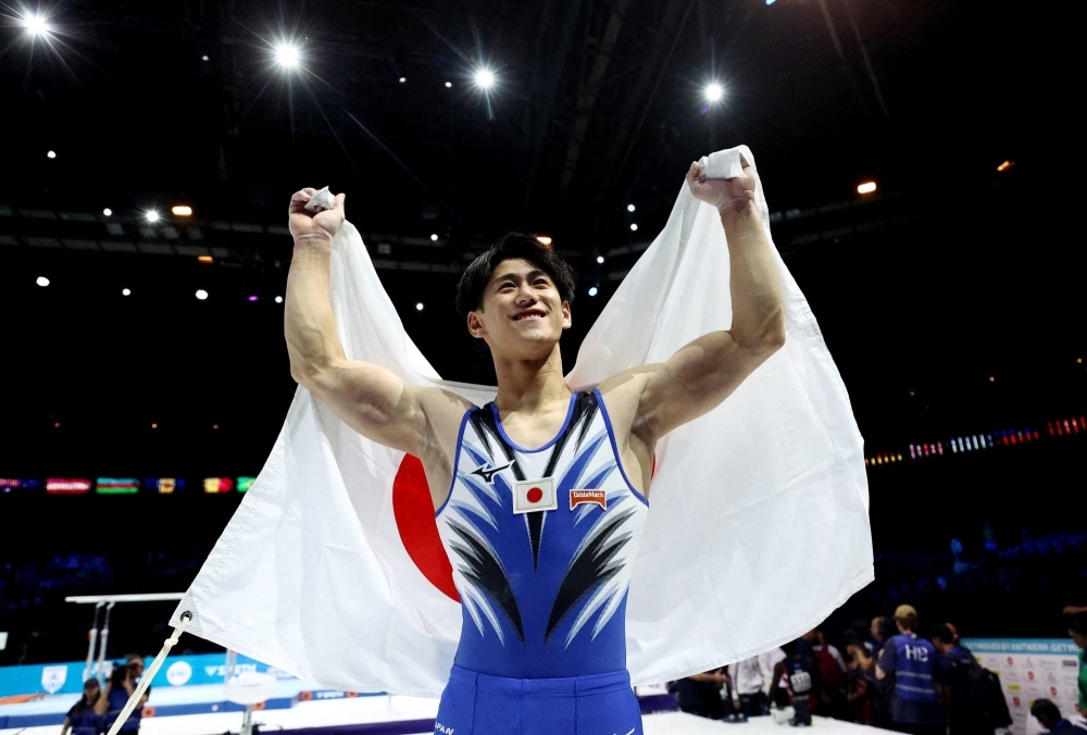 Daiki Hashimoto celebrates after winning gold in the men's all-around final at the FIG Artistic Gymnastics World Championships in Antwerp on Thursday.