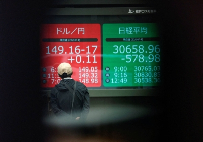 An electric monitor displays the yen exchange rate against the U.S. dollar and the Nikkei share average outside a brokerage in Tokyo on Wednesday.