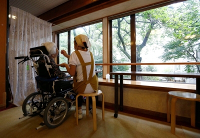 A carer feeds a resident at a nursing home in Tokyo.