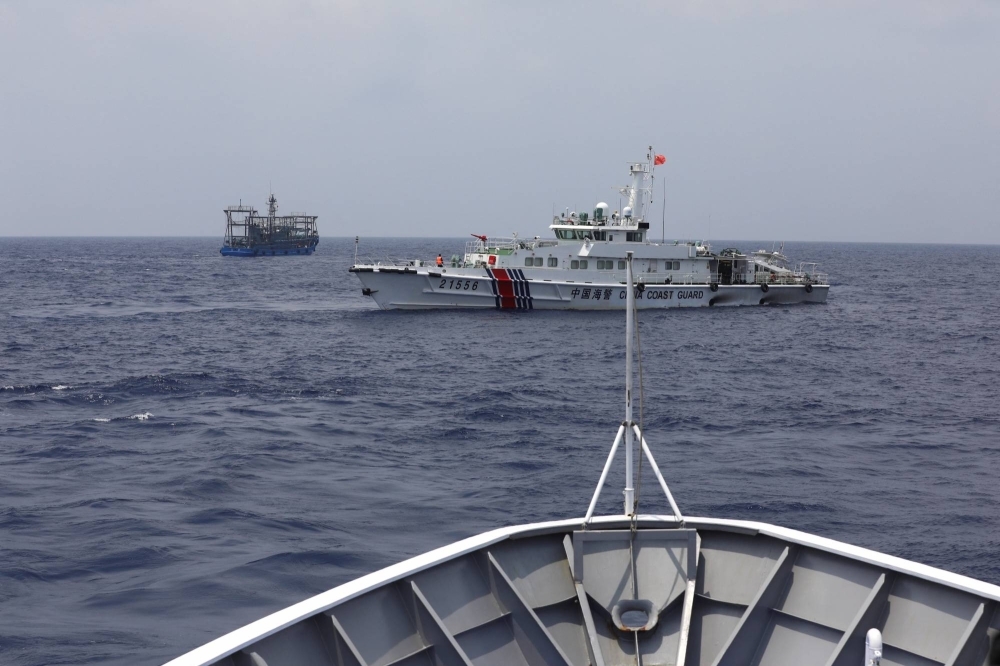 A China Coast Guard ship blocks the direction of a Philippine Coast Guard ship conducting a resupply mission for Filipino troops stationed at a grounded warship in the South China Sea on Wednesday.
