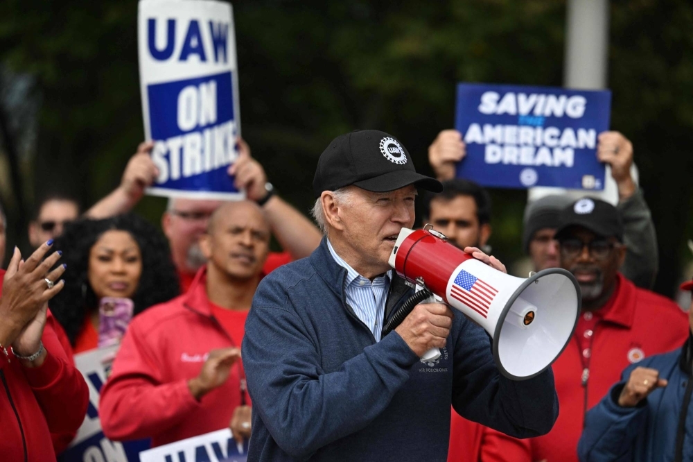 U.S. President Joe Biden joins members of the United Auto Workers union as they strike in Belleville, Michigan, on Sept. 26 to demand higher wages.