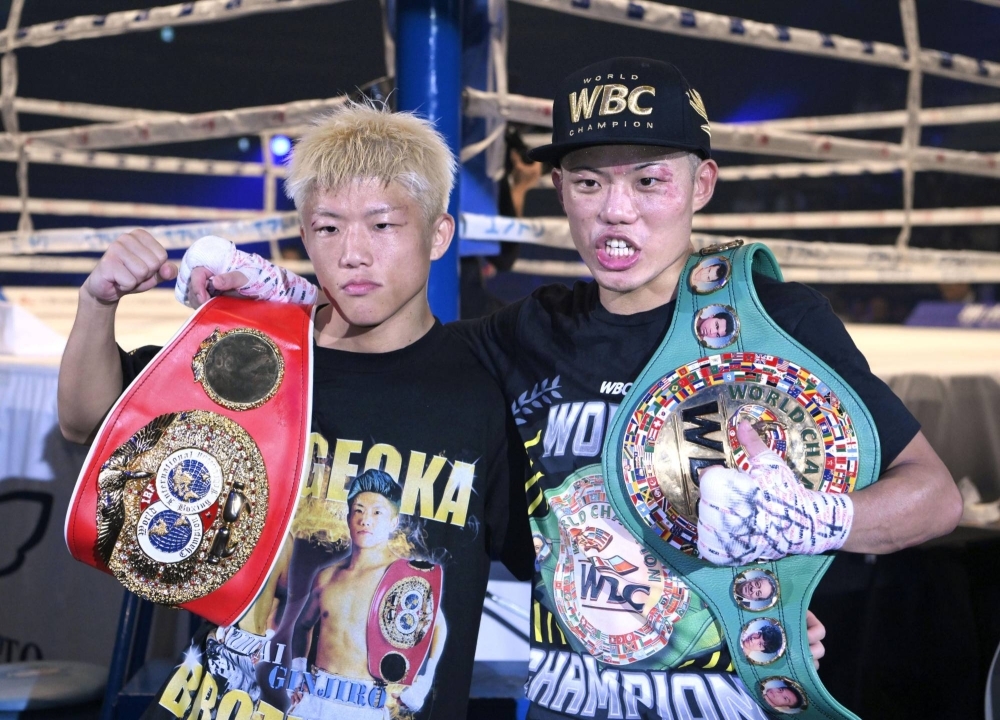 Ginjiro (left) and Yudai Shigeoka celebrate their minimumweight title wins at Ota City General Gymnasium on Saturday.