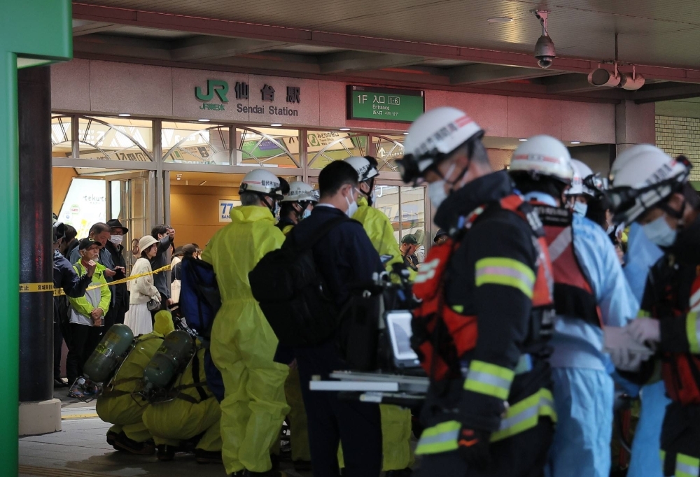 Firefighters arrive at Sendai Station following the report of a possible chemical leak inside a train on Monday.