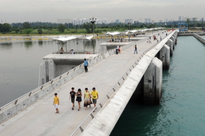 Visitors walk along the Marina Barrage water catchment area in Singapore in 2009.