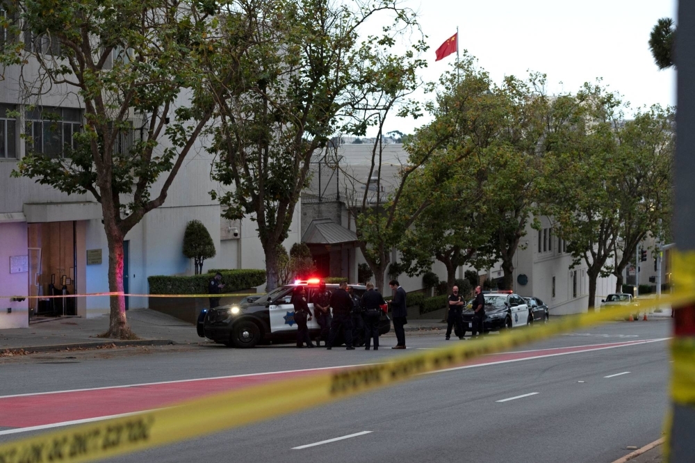 Police officers are seen where a vehicle crashed into the the visa office of the Chinese Consulate in San Francisco on Monday. The driver was shot dead.
