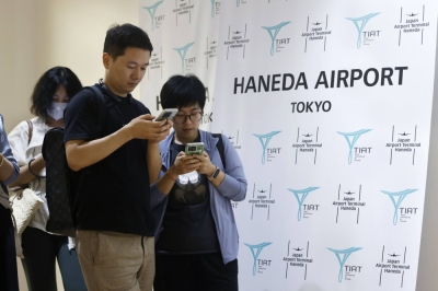 Chinese tourists arrive at Haneda Airport in Tokyo in August as China lifted a ban on group tours that month.