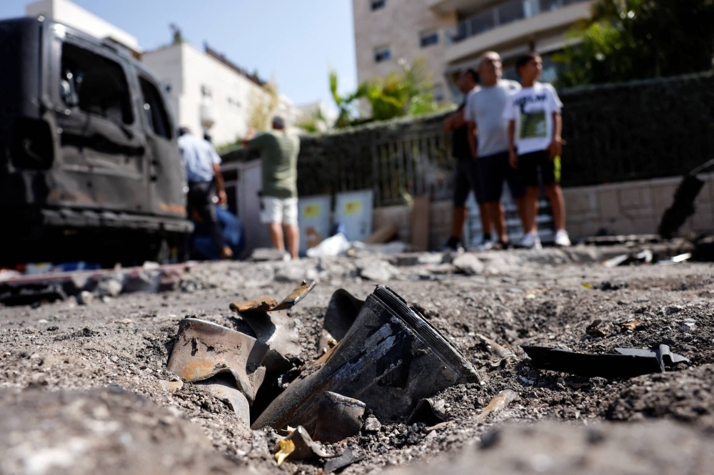 The remains of a rocket fired from the Gaza Strip into Israel lies on a road where it fell in Ashkelon, southern Israel, on Tuesday.