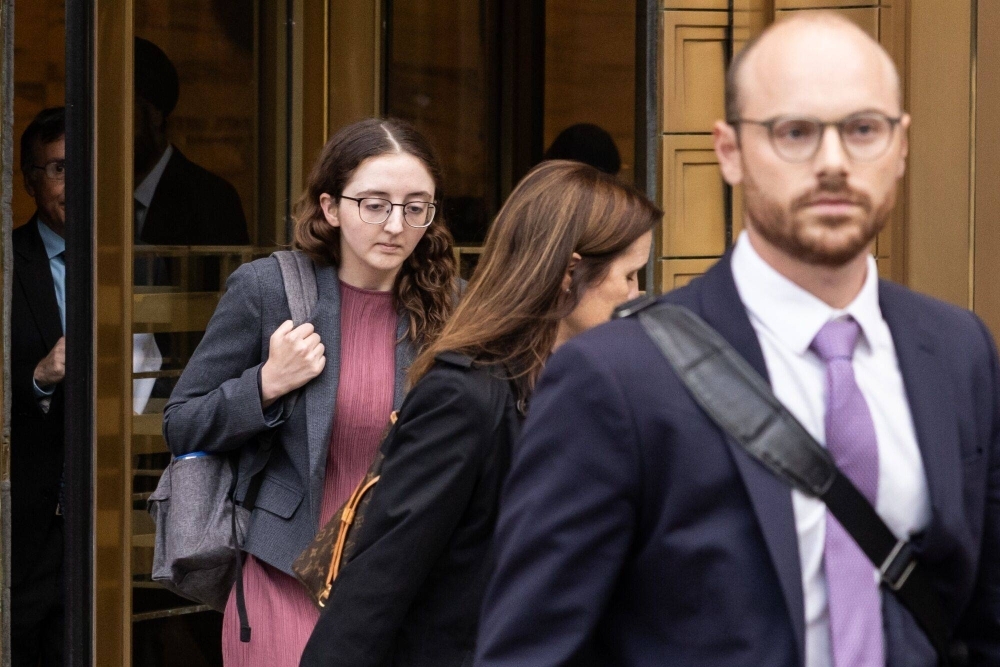 Caroline Ellison (left), former chief executive officer of Alameda Research LLC, exits court in New York on Tuesday. Her ex-boyfriend and former boss, FTX Co-Founder Sam Bankman-Fried, is charged with seven counts of fraud and money laundering following the collapse of his cryptocurrency empire last year.