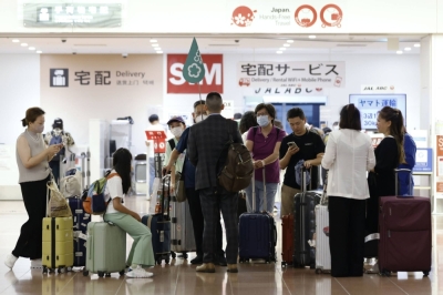 A group of Chinese tourists arrive at Haneda Airport in Tokyo in August.