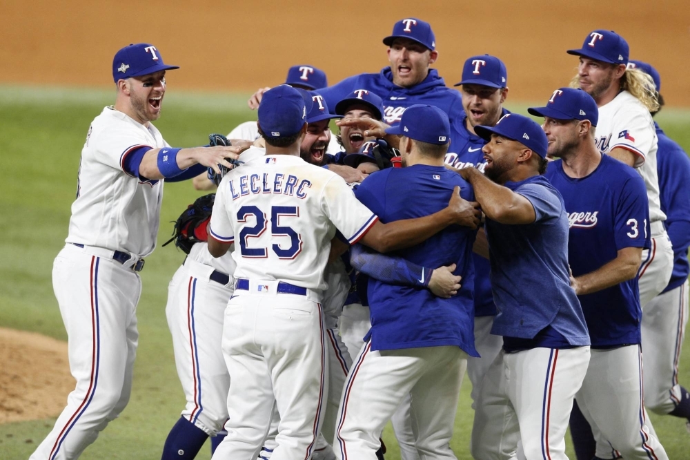 The Rangers celebrate after defeating the Orioles in Game 3 of the AL Division Series to advance to the ALCS in Arlington, Texas, on Tuesday.