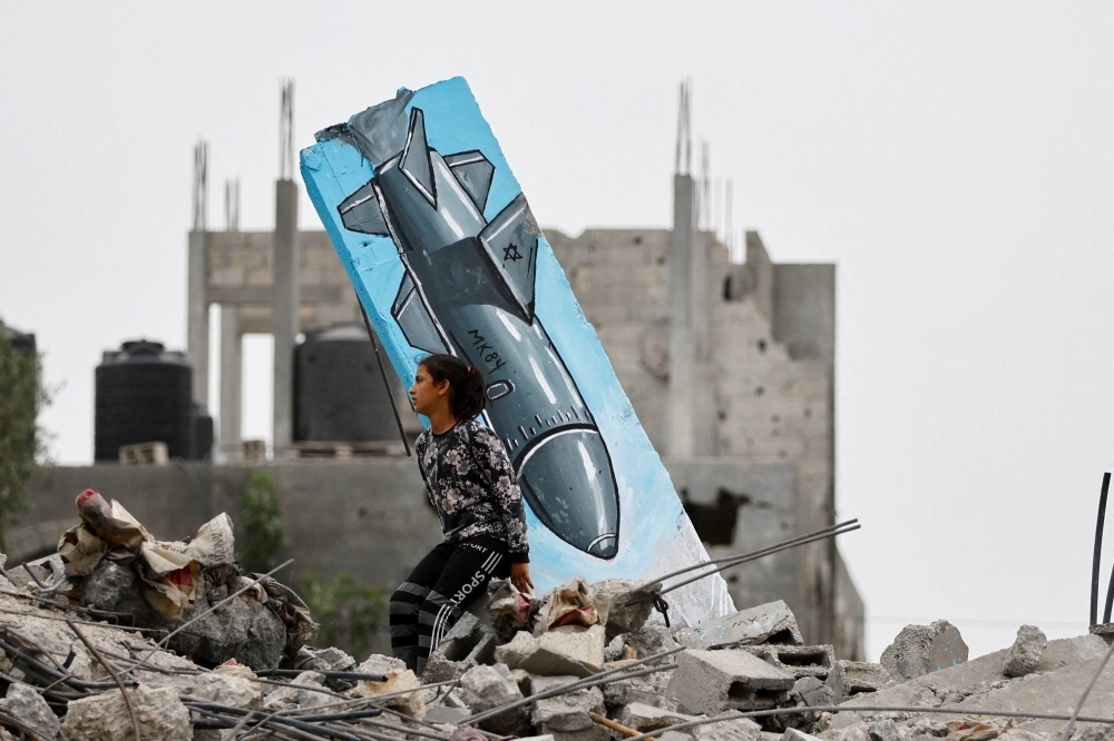 A Palestinian girl searches the remains of a house in Deir Al-Balah, central Gaza, that was destroyed during the recent Israeli-Hamas fighting on Sunday.