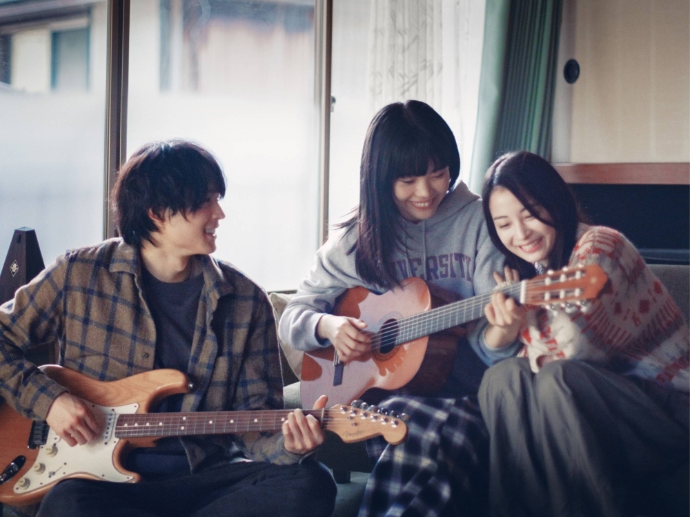 Singer-songwriter Aina The End (center) plays a young woman who strives to overcome her hardscrabble life and become an indie musician in “Kyrie.”