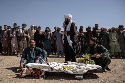 Sher Aqa, left, grieves over the body of his 12-year-old daughter, Roqia, during a funeral in the earthquake-ravaged village of Siaab, in Herat Province, Afghanistan, on Tuesday.