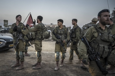 Israeli soldiers prepare for a mission outside Be’eri, a kibbutz that was overrun by Hamas militants on Saturday, in Israel, on Thursday.