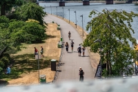 Visitors walk along a pathway surrounded by dry grass on a bank of the River Main in Frankfurt, Germany in June amid extremely hot temperatures. | Bloomberg