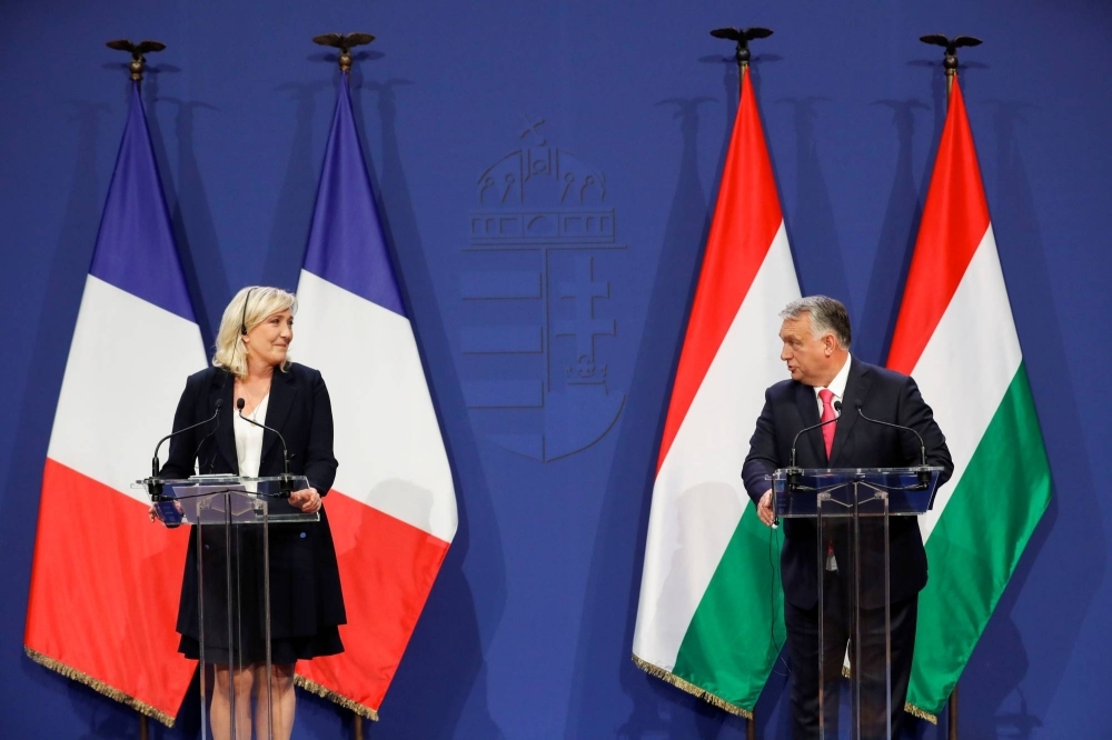 French far-right leader Marine Le Pen and Hungarian Prime Minister Viktor Orban meet in Budapest in October 2021. Modern autocrats focus on manipulating public opinion while gradually weakening the democratic institutions from which they claim legitimacy.