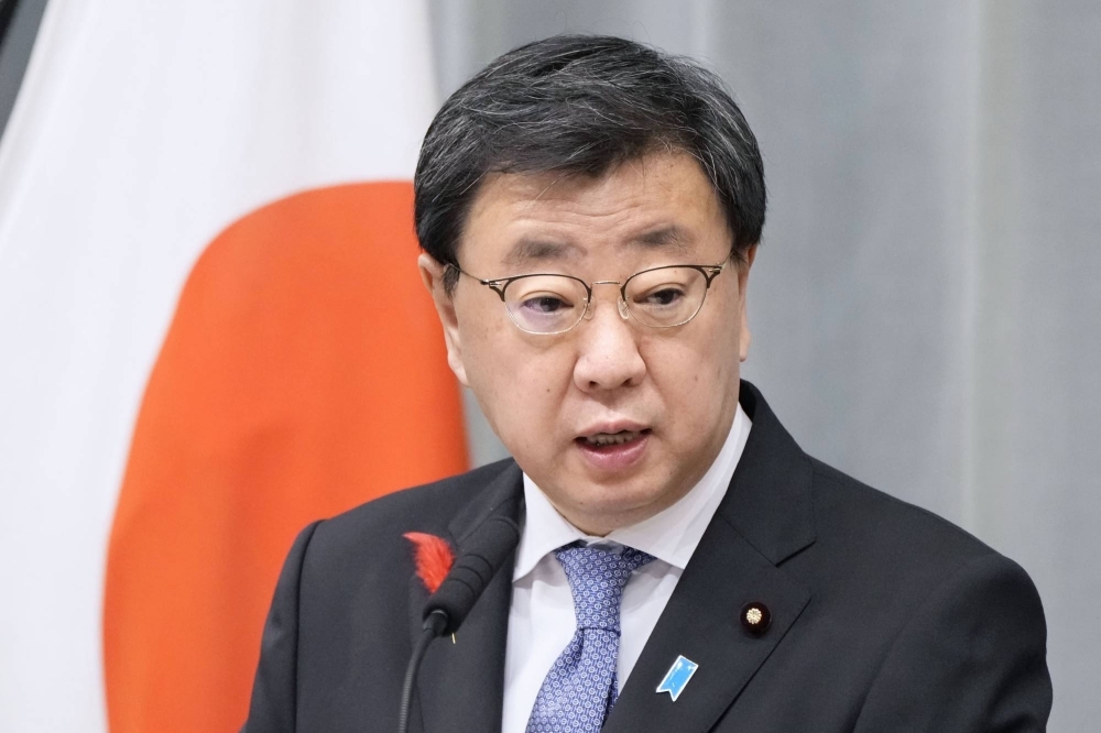 Chief Cabinet Secretary Hirokazu Matsuno speaks to reporters at a news conference on Friday in Tokyo.  