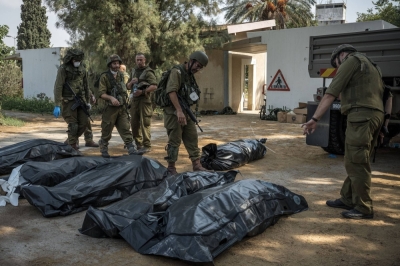 Israeli soldiers during searches of burned homes in Kfar Azza, a village just across the border from Gaza that was attacked by Palestinian gunmen, in Israel, on Tuesday.