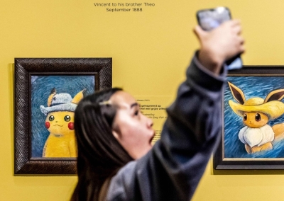 A visitor to the Vincent Van Gogh Museum in Amsterdam in September takes a picture of paintings inspired by Pokemon.