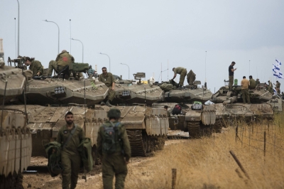 Israeli soldiers organize armored personnel  near the border with Lebanon on Sunday.