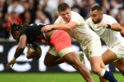 Fiji's outside center and captain Waisea Nayacalevu (left) is tackled by England fly-half and captain Owen Farrell during the France 2023 Rugby World Cup quarterfinal match between England and Fiji.