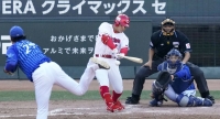 Carp batter Kosuke Tanaka hits to right field in the 8th inning of the team's second Central League Climax Series' first stage game against the BayStars at Mazda Stadium in Hiroshima on Sunday. | Kyodo