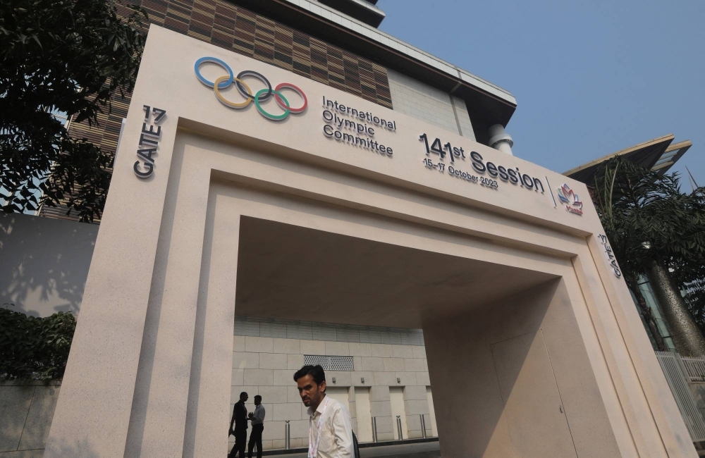 A man walks past the entrance of the 141st International Olympic Committee Session venue, in Mumbai, on Friday.