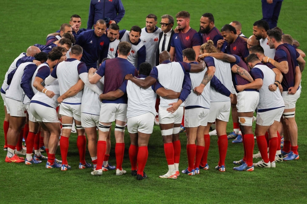 France's head coach Fabien Galthie (top, center) stands with his players ahead of the 2023 Rugby World Cup quarterfinal match between France and South Africa in Saint-Denis, France, on Sunday.
