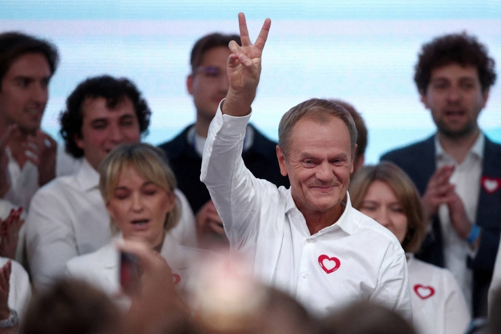 Donald Tusk, leader of the largest opposition grouping Civic Coalition (KO), gestures after the exit poll results are announced in Warsaw on Sunday. Poland's opposition is on course for a majority after Sunday's election, an upset that would deny the ruling nationalists a third term and see the country re-engage with the European Union.   
