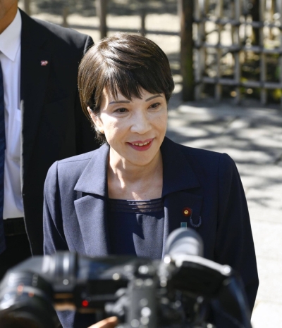 Economic security minister Sanae Takaichi speaks to reporters at Yasukuni Shrine in Tokyo on Tuesday.