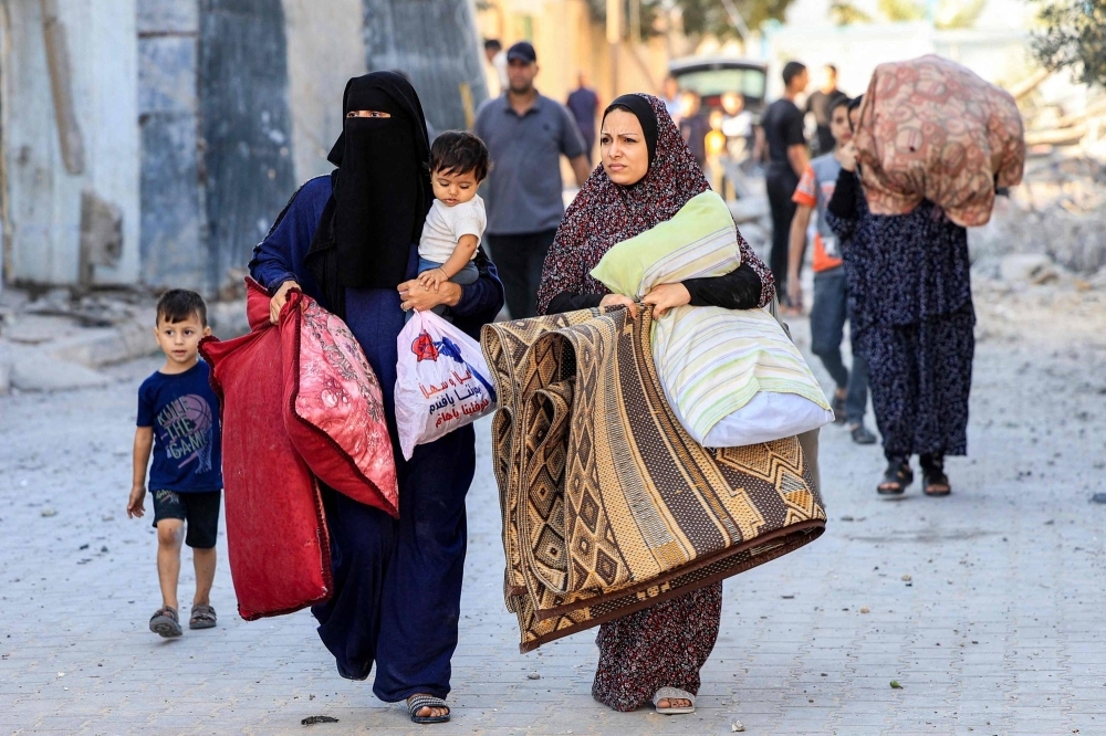 Palestinian refugees flee to Rafah, in southern Gaza, after Israeli airstrikes on Friday.