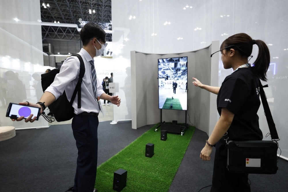 An attendee tries out the XR Catch game at the Sony Group booth at CEATEC in Chiba on Tuesday. 