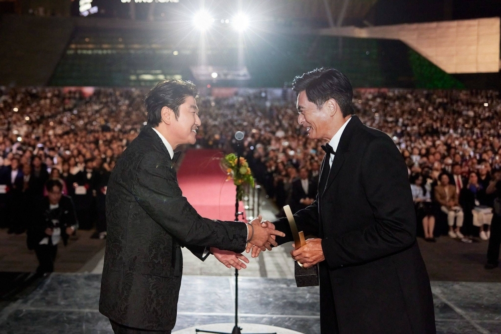 Busan International Film Festival host Song Kang-ho presents the Asian Filmmaker of the Year award to veteran Hong Kong star Chow Yun-fat at the 2023 edition of the Asian film festival.