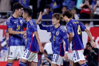 Kyogo Furuhashi (center) celebrates after scoring against Tunisia during an international friendly in Kobe on Tuesday.