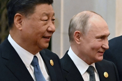 Russian President Vladimir Putin and Chinese leader Xi Jinping head to a group photo session during the third Belt and Road forum at the Great Hall of the People in Beijing on Wednesday.