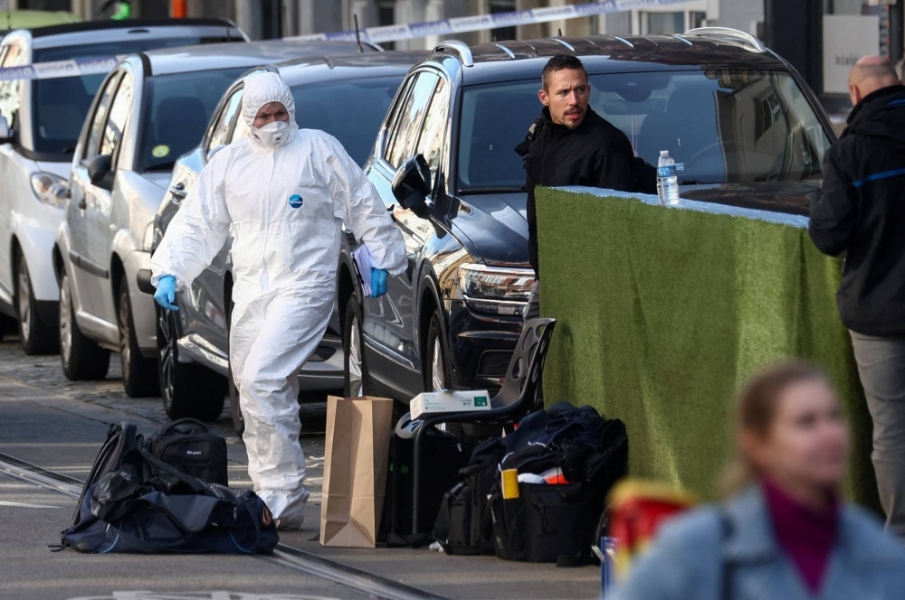 Police officers work after a operation against a deadly shooting suspect, in Schaerbeek, Brussels, on Tuesday.